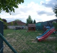 A garden with a slide at a 4-room apartment on Družstevná Street in Hamuliakovo.