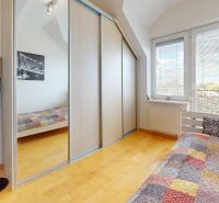 A bedroom with a wardrobe with sliding doors and a bed in a 4-room apartment.