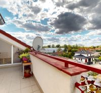 A balcony with a view of Družstevná Street in Hamuliakovo offers the space of a 4-room apartment.