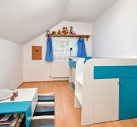 A children's room in a family house with blue decorations and a wooden decor floor.