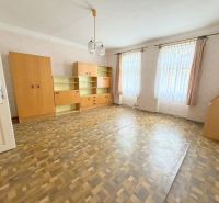 Spacious living room in a family house with built-in wardrobes and a wooden decor floor.