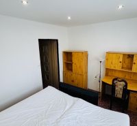 A room with a desk and wooden furniture in a 3-room apartment.