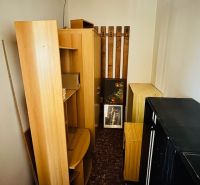 Storage room with wooden decor, shelves, and cabinets in a 3-room apartment.