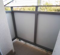A balcony in a 2-room apartment with a view of greenery in Nové Zámky.