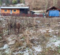 Wooden cabins on a snowy slope in Oščadnica near a family house.