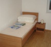 Single bed with a wooden floor decor in a 3-room apartment.