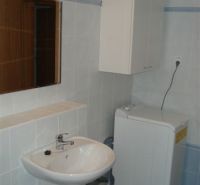 Bathroom in a 3-room apartment with a sink and a washing machine.