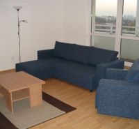 Living room with a sofa and a table in a 3-room apartment.