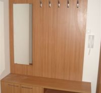 Hallway with coat hooks and a mirror, floor with wooden decor, in a 3-room apartment.