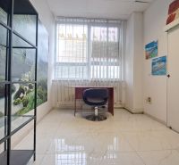 Office with white tiles and decorative paintings.