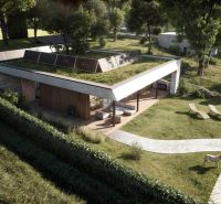 A family house in Častkovce with a terrace and a green roof, surrounded by nature.