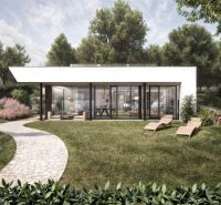 A family house in Častkovce with a glass facade, garden furniture, and a landscaped lawn.