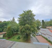 View from a 3-room apartment in Poprad to greenery and parking spaces in front of the buildings.