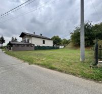 A plot for residential use in Medzianky, next to the road, with nearby wooded areas.