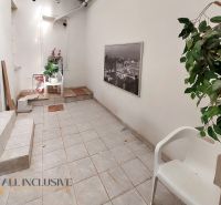 A hallway with ceramic tiles in a 2-room apartment, decorations and plastic chairs.