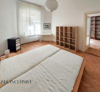 Bedroom with a built-in shelf, desk, and wood-decor flooring in a two-room apartment.