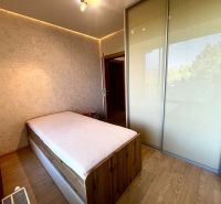 Bedroom in a 3-room apartment with a bed, built-in wardrobe, and decorative wall.