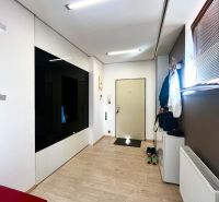 Entrance to a 3-room apartment with a wooden decor floor and practical storage space.