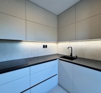A 3-room apartment kitchen with modern cabinets and LED lighting.