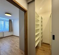 Room and wardrobe in a 3-room apartment with a wooden decor floor.