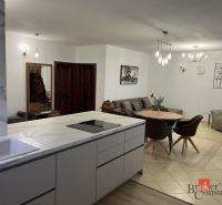Kitchen and living room with a dining table in a 3-room apartment.