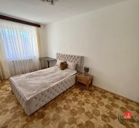 Bedroom with a bed, nightstand, and wooden-decor flooring, 3-room apartment.
