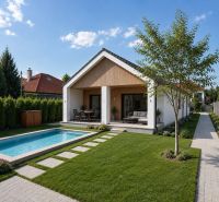 A garden at a family house with a swimming pool on a street in Veľká Mača under a blue sky.