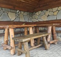 Rustic corner with wooden furniture and a stone wall in the Holiday Apartment.