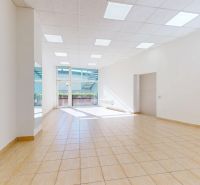 A bright commercial space with a light floor and large windows allowing the influx of natural light.