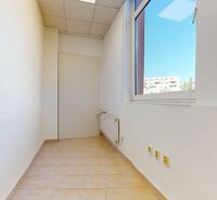 A narrow room with a large window, bright walls, and tiles, commercial space.
