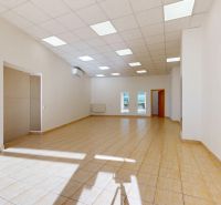 Spacious commercial spaces with white walls and light flooring.