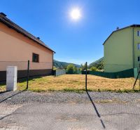 Building plot in Sebedín-Bečov on Sebedín Street, fenced, next to buildings.