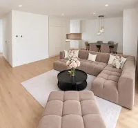 Living room in a family house with a wooden decor floor and a comfortable sofa.