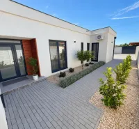 A family house in Čierna Voda on Čierna Voda Street with a paved entrance and landscaped garden.