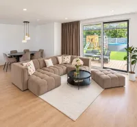The family house offers a spacious living room with a wooden decor floor and comfortable seating.