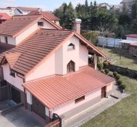A family house in Stará Ľubovňa with a garden and terrace, surrounded by landscaped greenery.