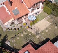 A family house in Stará Ľubovňa with a garden, lawn, gazebo, and solar panels on the roof.