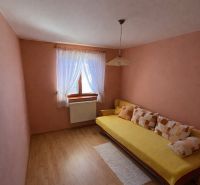 A room with wooden floor decor and a sofa in a family house.