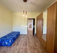 A room in a 2-room apartment with a wooden decor floor and furniture.