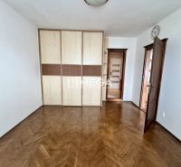 A room in a 3-room apartment with a wood-patterned floor and a built-in wardrobe.