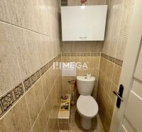 A bathroom with tiles and white furniture in a 3-room apartment.