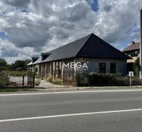 A family house in Nacina Ves with a modern sloped roof, visible from the road.