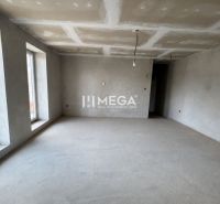 Interior of a family house with a neutral floor and a large window, ready for modifications.