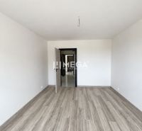 2-bedroom apartment with wood-patterned flooring and open doors.
