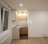 A kitchen in a holiday apartment with a kitchen unit and a wooden decor floor.