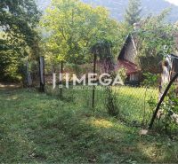 A cottage with a garden surrounded by a fence in the town of Humenné on the edge of nature.
