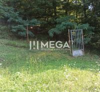 Gardens in Humenné with fencing and a gate, surrounded by greenery and forest in Humenné.