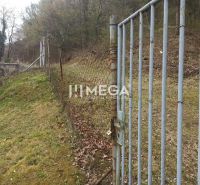 The gate and fence in the garden on the edge of the grove in Humenné on Záhrady Street.