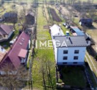 A view of a narrow residential plot in Ptičie on Ptičie Street, surrounded by houses.