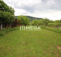 Green residential plots in Ptičie on Ptičie Street, surrounded by trees and mountains.